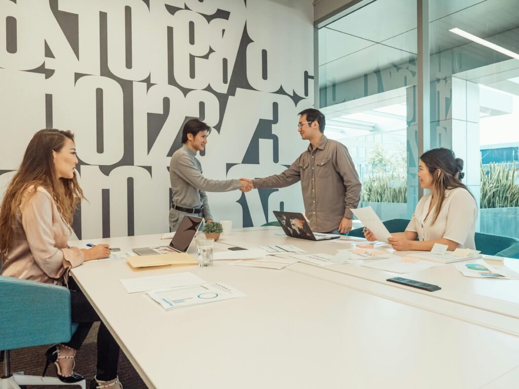 A diverse team of professionals discussing and collaborating in a modern office setting.